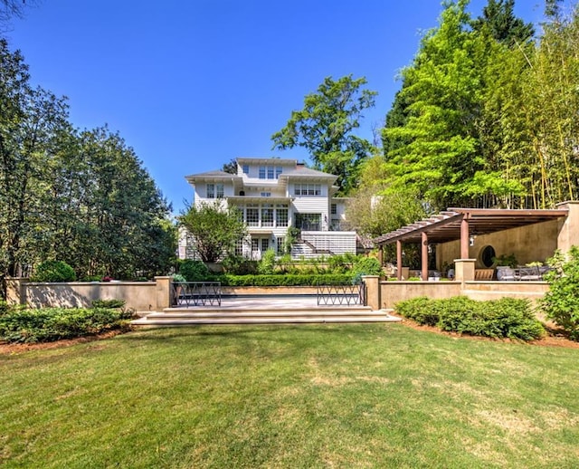 exterior space featuring a yard and a pergola