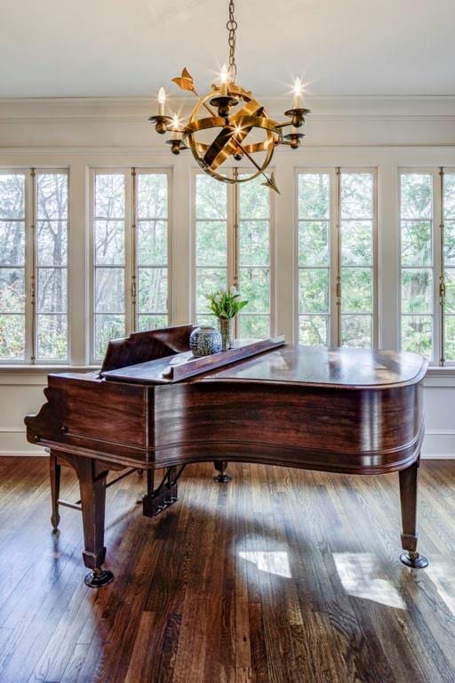 sunroom / solarium with a notable chandelier
