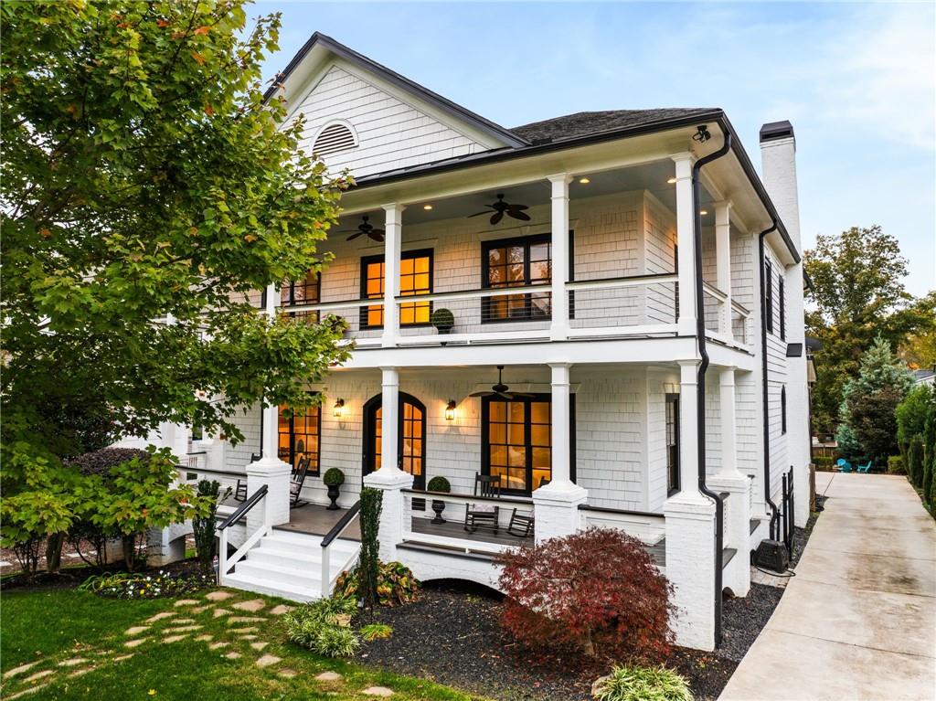 view of front of property featuring covered porch, a balcony, and ceiling fan