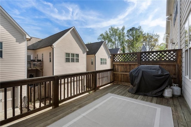 wooden deck featuring a grill