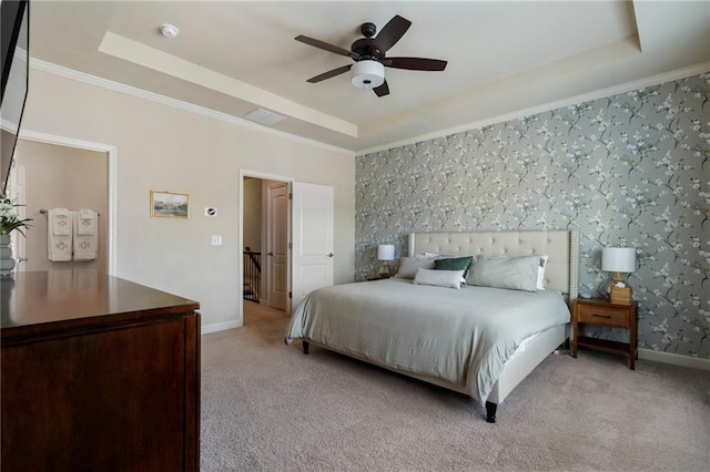 bedroom featuring crown molding, light carpet, a raised ceiling, baseboards, and wallpapered walls