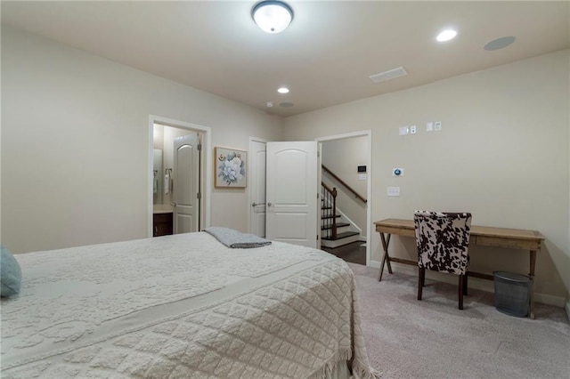 carpeted bedroom with baseboards, visible vents, recessed lighting, and connected bathroom