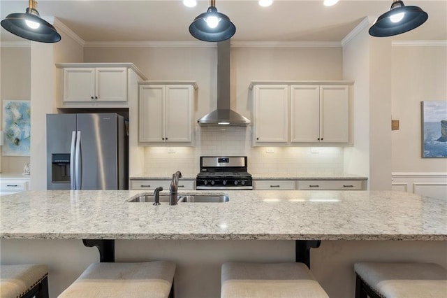 kitchen featuring decorative backsplash, wall chimney exhaust hood, light stone counters, a sink, and appliances with stainless steel finishes