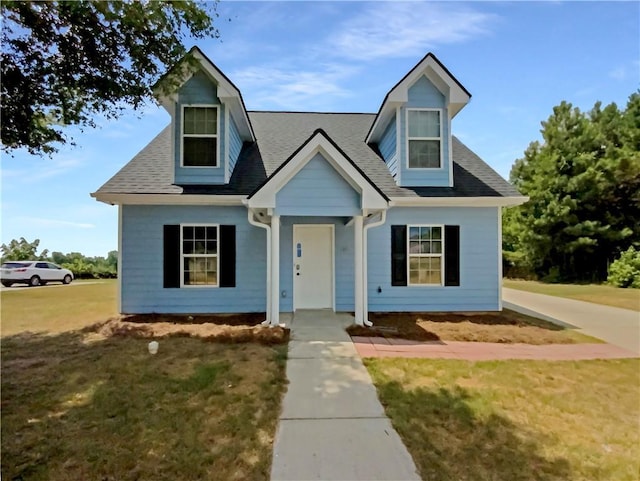 new england style home with a front lawn