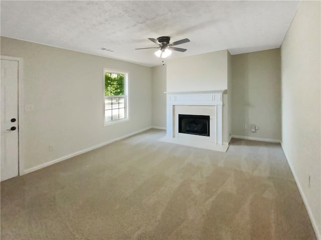 unfurnished living room featuring a textured ceiling, light colored carpet, and ceiling fan