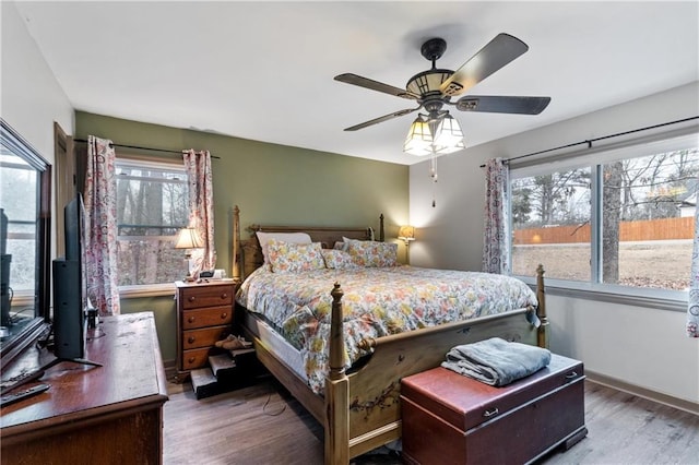 bedroom with hardwood / wood-style floors and ceiling fan