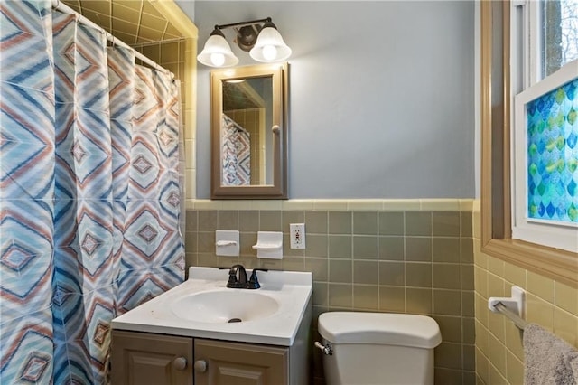 bathroom with vanity, tile walls, a shower with shower curtain, and toilet