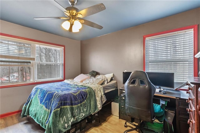 bedroom with hardwood / wood-style floors and ceiling fan