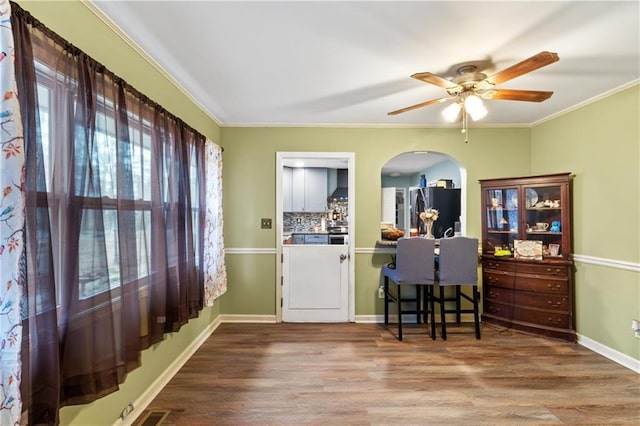 interior space featuring crown molding, ceiling fan, and hardwood / wood-style flooring