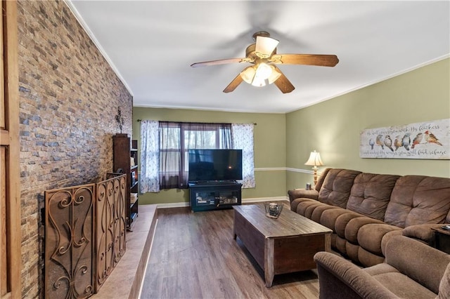 living room with ceiling fan, ornamental molding, and hardwood / wood-style floors