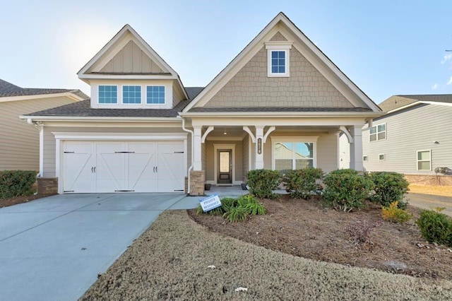 craftsman house featuring covered porch and a garage