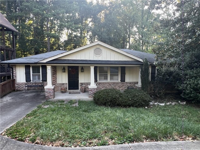 2713 Valvedere Dr NE, Atlanta, GA 30319 - view of front of home with brick siding, board and batten siding, a front lawn, and covered porch