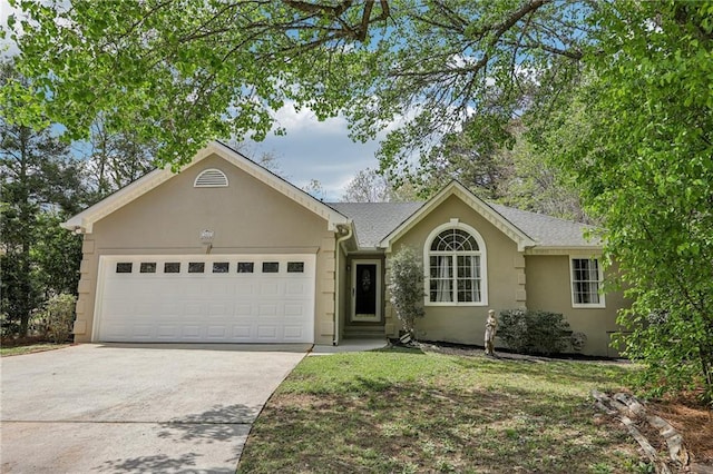 ranch-style home with an attached garage, stucco siding, and driveway