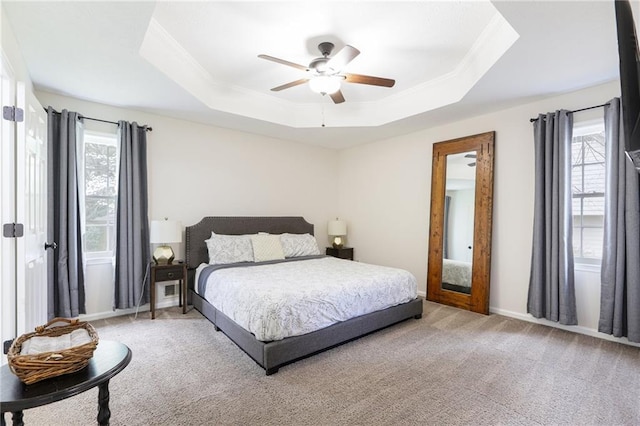 bedroom featuring carpet flooring, crown molding, ceiling fan, and a raised ceiling