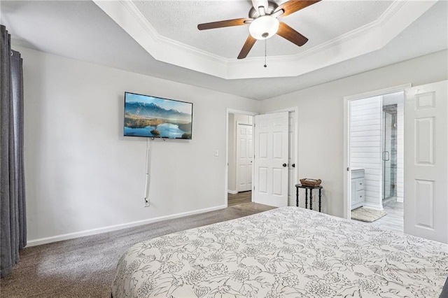 bedroom with crown molding, a raised ceiling, baseboards, and carpet flooring