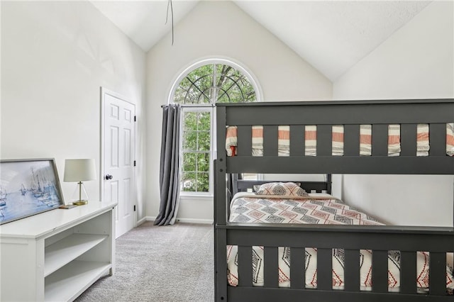 bedroom with baseboards, carpet flooring, and high vaulted ceiling