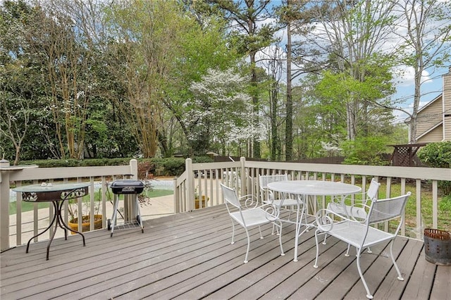 wooden deck with outdoor dining space