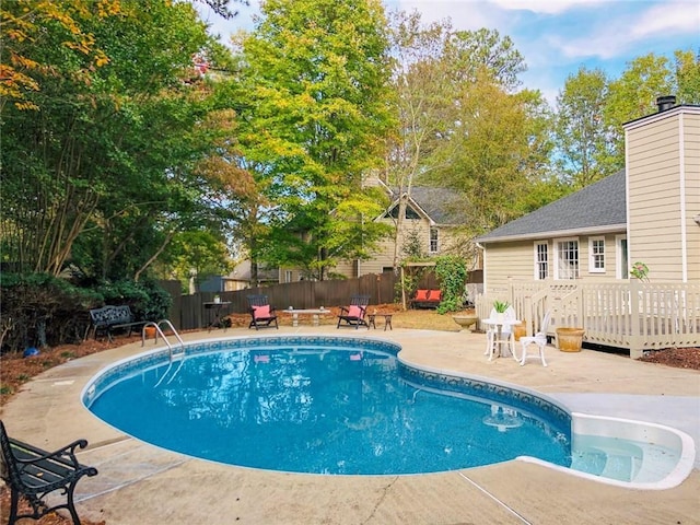 view of swimming pool with a fenced backyard, a fenced in pool, a patio area, and a deck