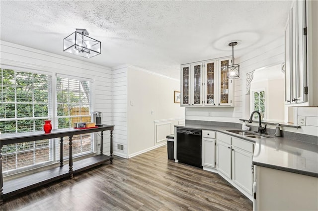 kitchen featuring dark countertops, a textured ceiling, and dishwasher