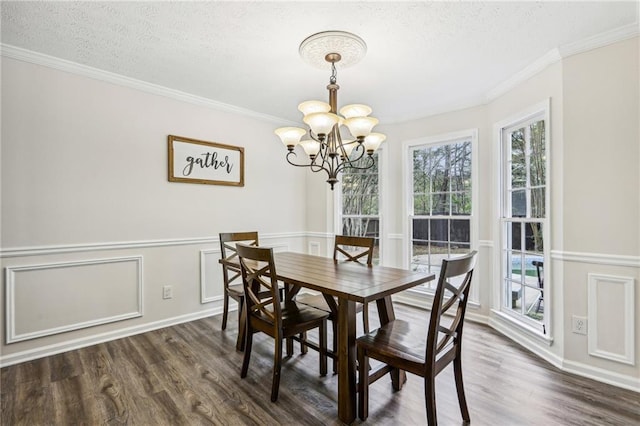 dining area featuring an inviting chandelier, ornamental molding, and dark wood-style floors