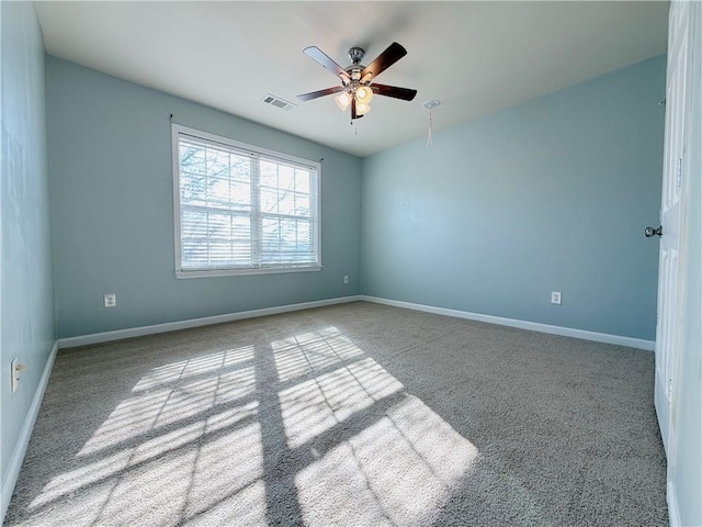 unfurnished room featuring light colored carpet and ceiling fan