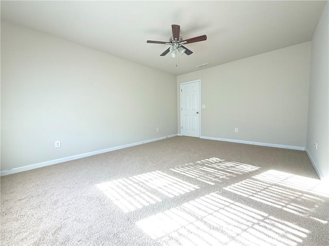 spare room with light colored carpet and ceiling fan