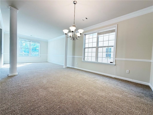 empty room featuring decorative columns, ornamental molding, carpet flooring, and an inviting chandelier