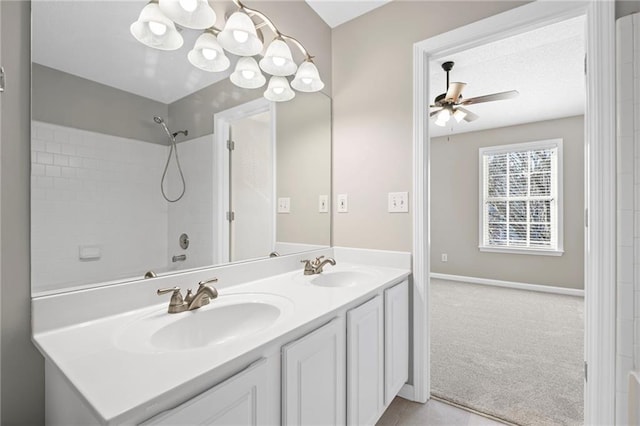 full bath featuring a sink, baseboards, a ceiling fan, and double vanity