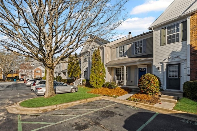 uncovered parking lot with a residential view