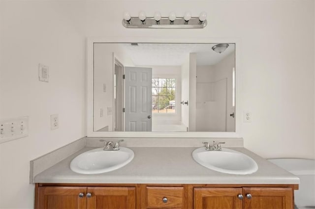 full bath featuring a sink and double vanity