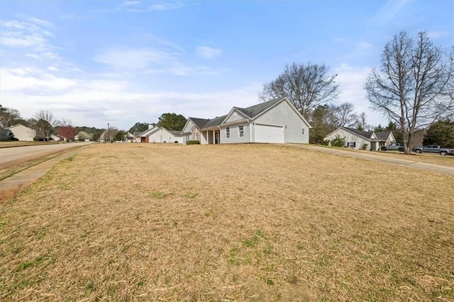 view of front of property with driveway, a front lawn, and an attached garage