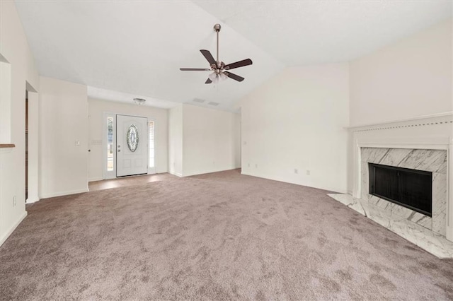 unfurnished living room with a fireplace, lofted ceiling, a ceiling fan, and carpet floors