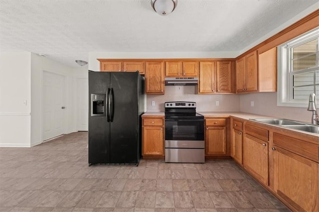 kitchen with under cabinet range hood, a sink, light countertops, stainless steel electric range oven, and black refrigerator with ice dispenser