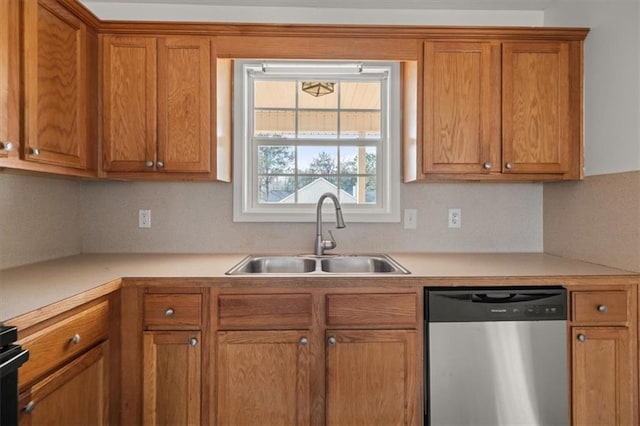 kitchen with dishwasher, light countertops, brown cabinets, and a sink