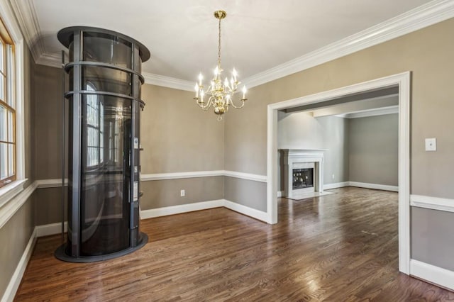 unfurnished living room featuring crown molding, dark hardwood / wood-style floors, and an inviting chandelier