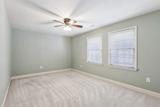 unfurnished room with light carpet and ceiling fan