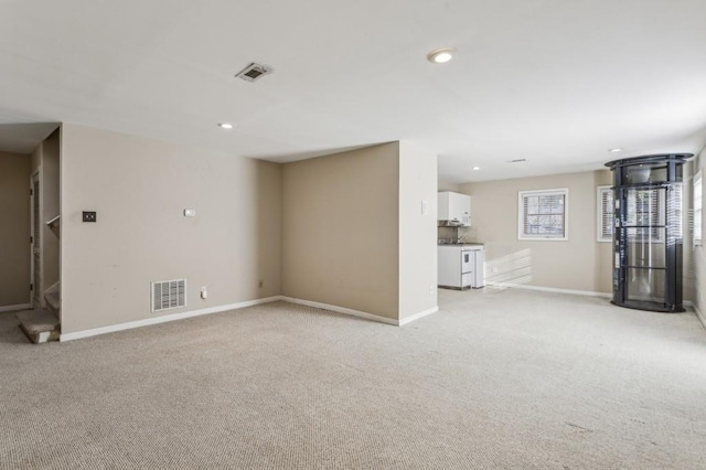 unfurnished living room with light carpet