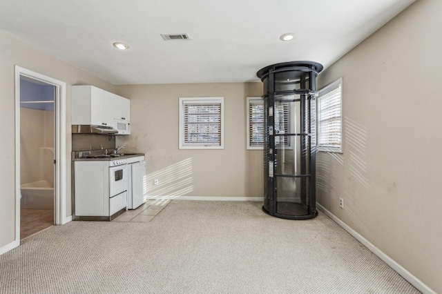 kitchen featuring white cabinetry, white appliances, sink, and light colored carpet