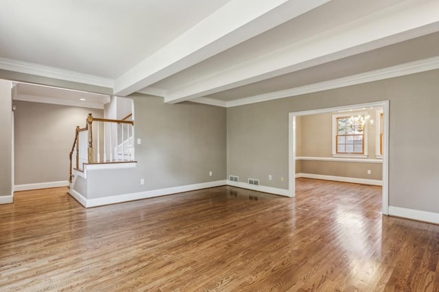 empty room featuring beam ceiling, hardwood / wood-style flooring, ornamental molding, and a chandelier