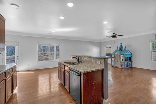 kitchen featuring stainless steel dishwasher, crown molding, ceiling fan, a sink, and open floor plan