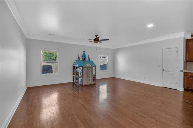 empty room featuring ceiling fan, dark wood-style floors, baseboards, ornamental molding, and recessed lighting