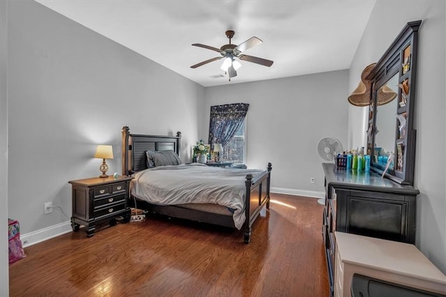 bedroom featuring baseboards, dark wood finished floors, and ceiling fan