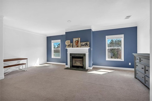 unfurnished living room featuring crown molding, a fireplace with flush hearth, baseboards, and carpet floors