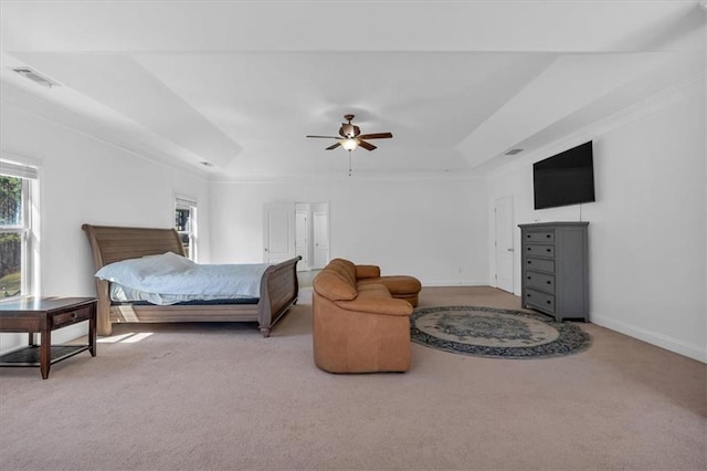carpeted bedroom with multiple windows, a raised ceiling, baseboards, and a ceiling fan