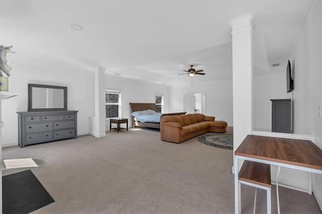 living room with carpet floors, ceiling fan, and decorative columns