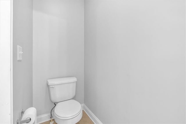 bathroom with baseboards and toilet