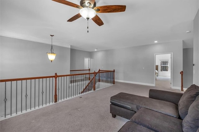 carpeted living room with a ceiling fan, baseboards, and recessed lighting
