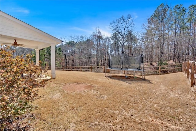view of yard featuring a ceiling fan and a trampoline