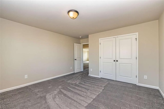 unfurnished bedroom with a closet, baseboards, and carpet floors