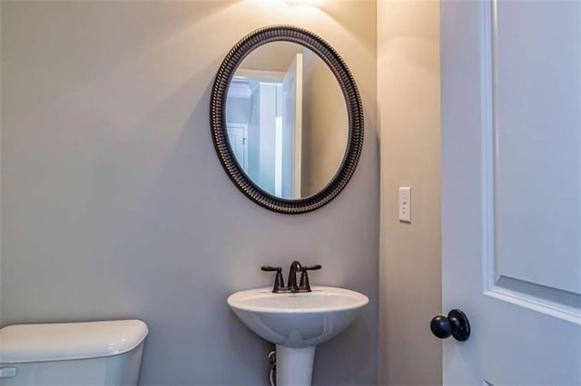 bathroom featuring toilet and a sink